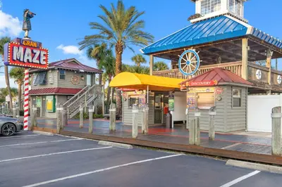 a building with a restaurant and a sign in a parking lot at 3BD, 2BA Home! Family Friendly! Close to Beach! HOT TUB! in Panama City Beach
