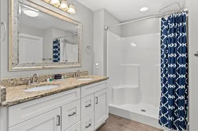 a bathroom with two sinks and a shower at 3BD, 2BA Home! Family Friendly! Close to Beach! HOT TUB! in Panama City Beach