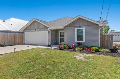 a house with a garden in the front yard at 3BD, 2BA Home! Family Friendly! Close to Beach! HOT TUB! in Panama City Beach