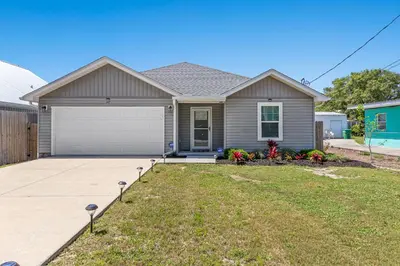 a house with a driveway and a garage at 3BD, 2BA Home! Family Friendly! Close to Beach! HOT TUB! in Panama City Beach