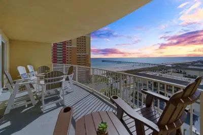 a balcony with chairs and a view of the beach at Calypso 3 Luxury Beach Vacation Sleeps 6 in Panama City Beach