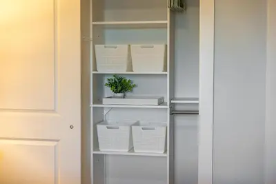 a closet with white shelves and a plant in it at Calypso 3 Luxury Beach Vacation Sleeps 6 in Panama City Beach