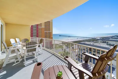a balcony with chairs and a view of the beach at Calypso 3 Luxury Beach Vacation Sleeps 6 in Panama City Beach