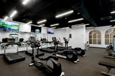 a gym with treadmills and elliptical machines at Calypso 3 Luxury Beach Vacation Sleeps 6 in Panama City Beach