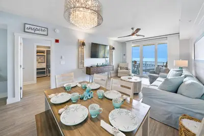 a living room with a couch and a table at Calypso 3 Luxury Beach Vacation Sleeps 6 in Panama City Beach
