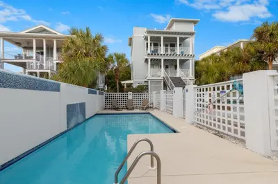 a swimming pool in a villa with palm trees at Book This Top Rated Luxury Home in Seagrove Now! Private Pool! in Santa Rosa Beach