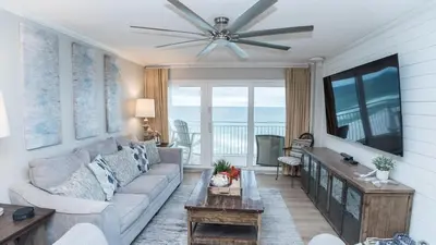 a living room with a couch and a ceiling fan at 5-STAR Beachfront - 2br & 2ba Total Remodel - Dunes of Panama D1105 in Panama City Beach