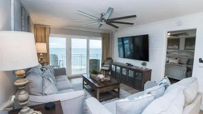 a living room with a couch and a tv at 5-STAR Beachfront - 2br & 2ba Total Remodel - Dunes of Panama D1105 in Panama City Beach
