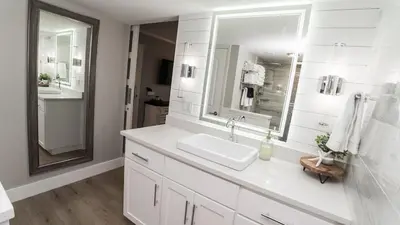 a white bathroom with a sink and a mirror at 5-STAR Beachfront - 2br & 2ba Total Remodel - Dunes of Panama D1105 in Panama City Beach