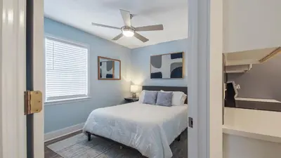 a bedroom with a bed and a ceiling fan at Red Neptune by Nautical Properties in Panama City Beach