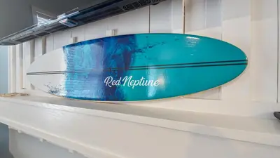 a blue surfboard sitting on top of a shelf at Red Neptune by Nautical Properties in Panama City Beach