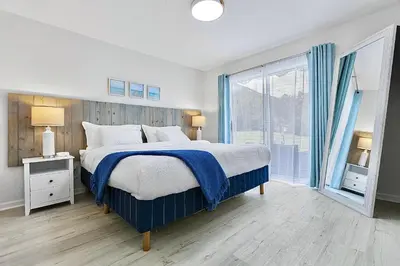 a bedroom with a bed and a large window at Lagoon 2621 by Nautical Properties in Panama City Beach