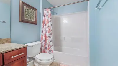 a bathroom with a toilet and a shower at The Tide View at Laketown Wharf #904 by Nautical Properties in Panama City Beach