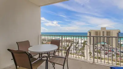 a balcony with a table and chairs and a view of the ocean at The Tide View at Laketown Wharf #904 by Nautical Properties in Panama City Beach