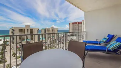 a balcony with a table and chairs and the ocean at The Tide View at Laketown Wharf #904 by Nautical Properties in Panama City Beach