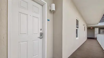an empty hallway with a white door in a building at The Tide View at Laketown Wharf #904 by Nautical Properties in Panama City Beach