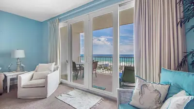 a living room with a view of the ocean at The Tide View at Laketown Wharf #904 by Nautical Properties in Panama City Beach