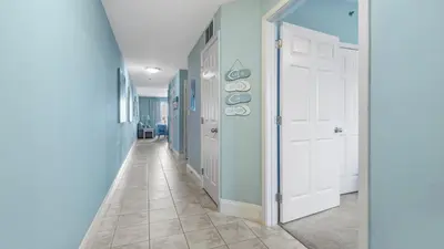 a hallway with blue walls and a white door at The Tide View at Laketown Wharf #904 by Nautical Properties in Panama City Beach