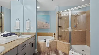 a bathroom with a tub and a sink and a shower at Some Beach Some Where at Laketown Wharf #825 by Nautical Properties in Panama City Beach