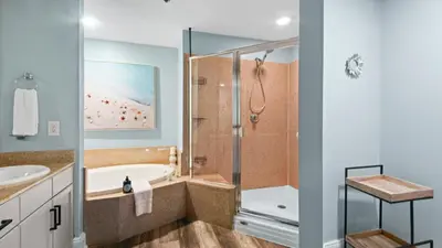 a bathroom with a tub and a shower at Some Beach Some Where at Laketown Wharf #825 by Nautical Properties in Panama City Beach