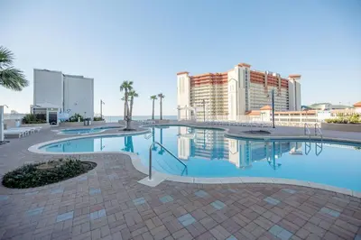 a large swimming pool with buildings in the background at Some Beach Some Where at Laketown Wharf #825 by Nautical Properties in Panama City Beach