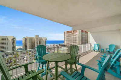 a balcony with a table and chairs and the ocean at Beachy King at Laketown Wharf #812 by Nautical Properties in Panama City Beach