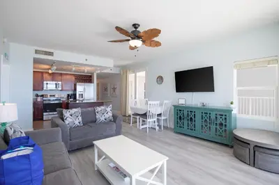 a living room with a couch and a flat screen tv at Bikini Bottom at Laketown Wharf #501 by Nautical Properties in Panama City Beach