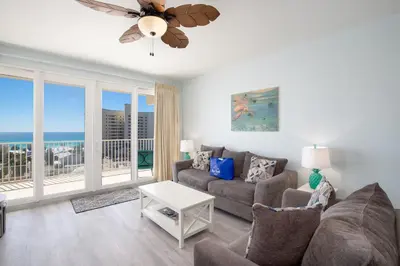 a living room with a couch and a table at Bikini Bottom at Laketown Wharf #501 by Nautical Properties in Panama City Beach