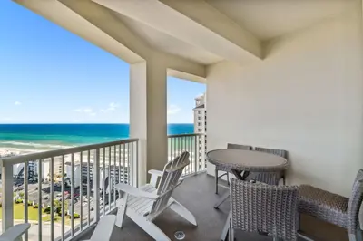 a balcony with a table and chairs and the ocean at Grand Panama #2-1307 in Panama City Beach