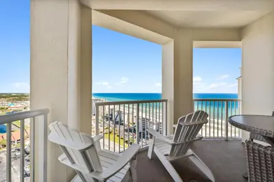 a balcony with chairs and a table with a view of the ocean at Grand Panama #2-1307 in Panama City Beach