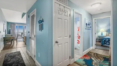 a hallway with a room with blue walls at Sunsational at Laketown Wharf #1924 by Nautical Properties in Panama City Beach
