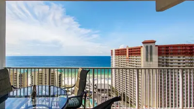 a balcony with a table and chairs and the ocean at Sunsational at Laketown Wharf #1924 by Nautical Properties in Panama City Beach