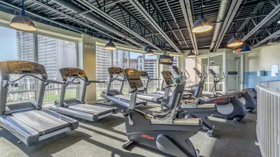 a gym with cardio equipment in a building at Sunsational at Laketown Wharf #1924 by Nautical Properties in Panama City Beach