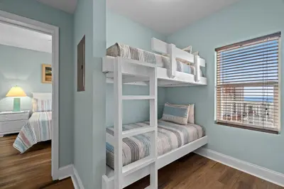 a bedroom with two bunk beds and a window at Deja Blue at Laketown Wharf #1831 by Nautical Properties in Panama City Beach