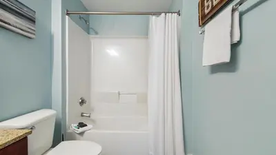 a bathroom with a toilet and a shower at Laketown Wharf #1819 by Nautical Properties in Panama City Beach