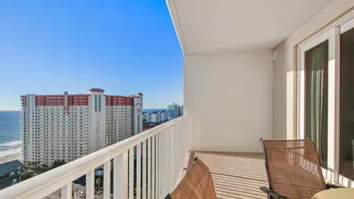 a balcony with a view of the ocean and a building at Laketown Wharf #1819 by Nautical Properties in Panama City Beach