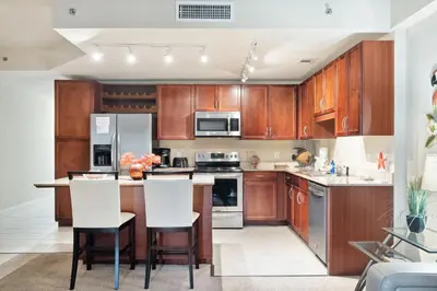 a kitchen with wooden cabinets and white appliances at Laketown Wharf #1737 by Nautical Properties in Panama City Beach
