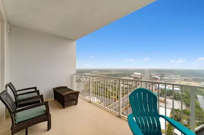a room with two chairs and a balcony with a view at Laketown Wharf #1737 by Nautical Properties in Panama City Beach