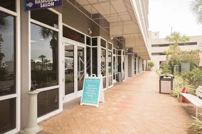 a building with a sign in the middle of a sidewalk at Laketown Wharf #1737 by Nautical Properties in Panama City Beach