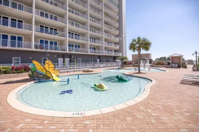 a pool in front of a large apartment building at Laketown Wharf #1737 by Nautical Properties in Panama City Beach