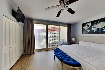 a bedroom with a large bed and a ceiling fan at Shores of Panama #1823 in Panama City Beach