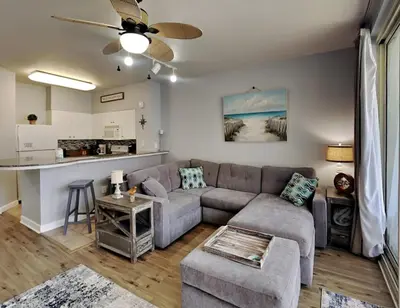 a living room with a couch and a table at Shores of Panama #1823 in Panama City Beach