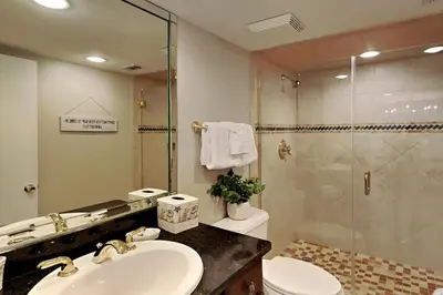 a bathroom with a toilet and a sink and a shower at Edgewater Tower Iii 612 in Panama City Beach