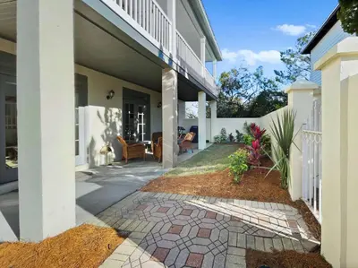 a house with a walkway leading to a porch at Beach Music in Rosemary Beach