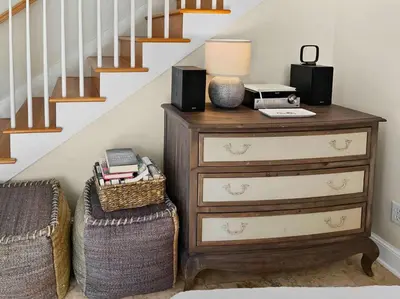 a dresser with speakers on it next to a staircase at Beach Music in Rosemary Beach