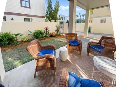 a group of chairs and tables on a patio at Beach Music in Rosemary Beach