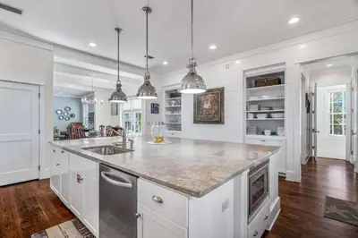 a white kitchen with a sink and a counter at Flagship of Watersound in Watersound Beach