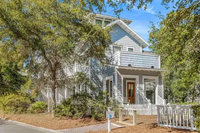 a white house with a white fence in front of it at Flagship of Watersound in Watersound Beach