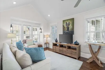 a living room with a couch and a tv at Flagship of Watersound in Watersound Beach