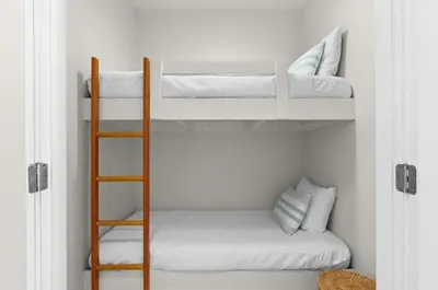 a room with two bunk beds and a ladder at Front Row in Inlet Beach